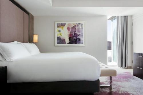 a white bedroom with a large bed and a window at Loews Atlanta Hotel in Atlanta