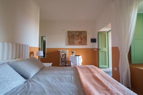 a bedroom with a bed and a green door at Agriturismo Il Belvedere in Palazzago