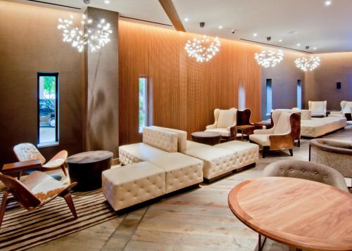 a waiting room with couches and tables and chairs at Loews Nashville Hotel at Vanderbilt Plaza in Nashville