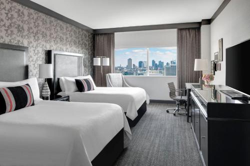 a hotel room with two beds and a window at Loews Nashville Hotel at Vanderbilt Plaza in Nashville