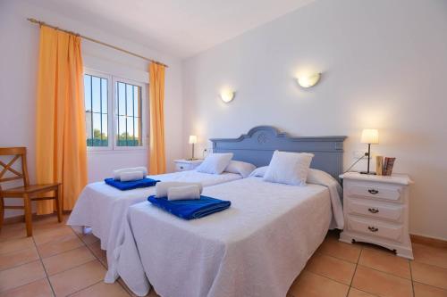 a bedroom with two beds with towels on them at Monte Malva in Jávea