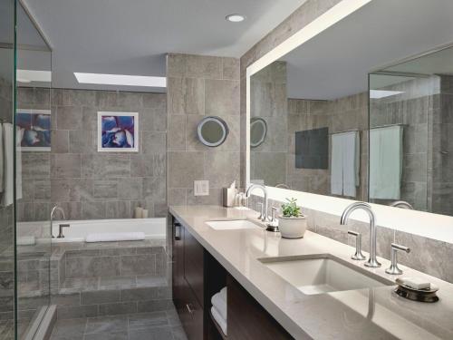 a bathroom with two sinks and a bath tub at Loews Ventana Canyon Resort in Tucson