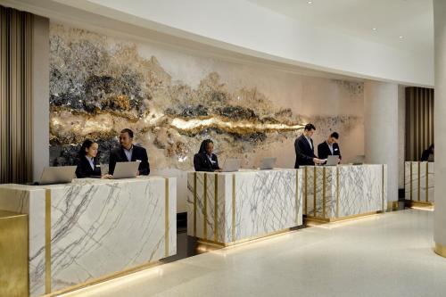 a group of people sitting at a desk with laptops at Loews Miami Beach Hotel in Miami Beach