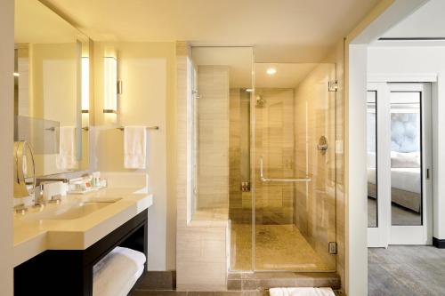 a bathroom with a sink and a shower at Loews Miami Beach Hotel in Miami Beach