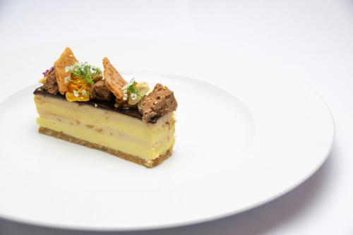 a piece of cake on a white plate at Nunsmere Hall Hotel in Oakmere