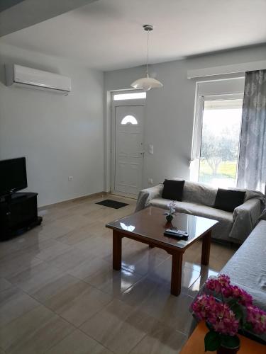 a living room with a couch and a coffee table at Katerina Villa In Kiotari in Kiotari
