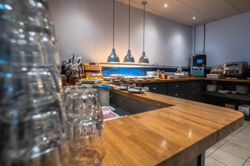 a kitchen with a counter with wine glasses on it at Castlefield Hotel in Manchester