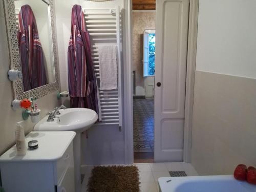 a white bathroom with a sink and a shower at Villa Casale Settesoldi in Salemi