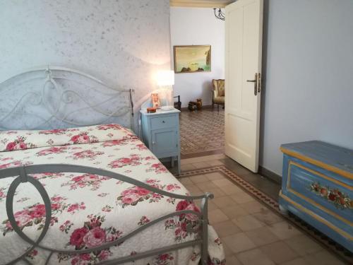 a bedroom with a bed and a blue dresser and a door at Villa Casale Settesoldi in Salemi