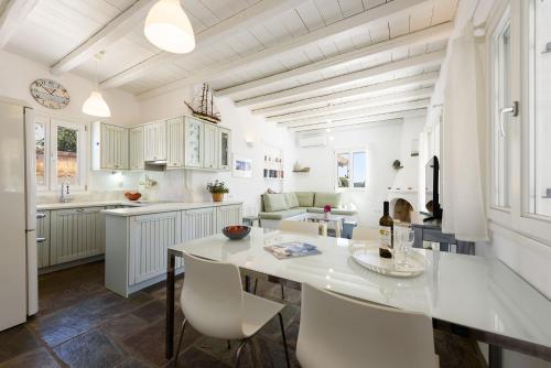 a kitchen with a large white table and chairs at A Delight House in Maráthion