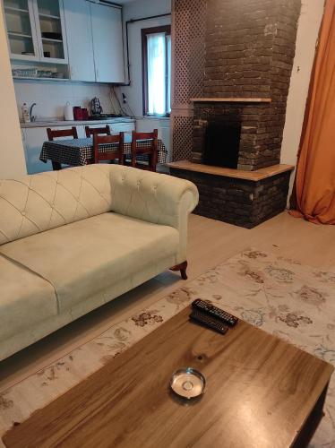 a living room with a couch and a coffee table at Ağva'da Villa in Sile