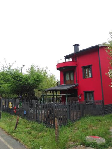 a red house with a fence in front of it at Ağva'da Villa in Sile