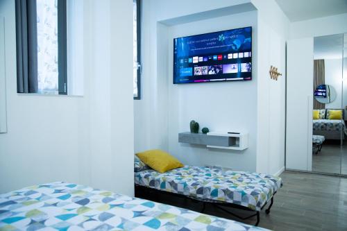 a bedroom with a bed and a tv on the wall at STUDIO 47 - CITY LIFE in Milan
