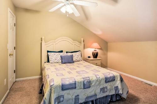 a bedroom with a bed and a ceiling fan at 2 Pools Waterfront Condo on Lake of the Ozarks! in Camdenton