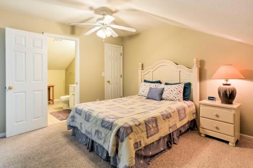 a bedroom with a bed and a ceiling fan at 2 Pools Waterfront Condo on Lake of the Ozarks! in Camdenton