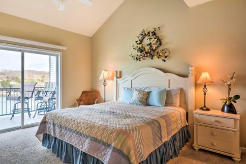 a bedroom with a bed and a balcony at Waterfront Condo on Lake of the Ozarks with 2 Pools! in Camdenton