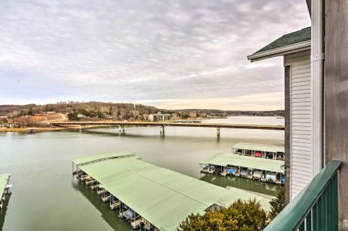 a view of a river with a dock and a bridge at 2 Pools Waterfront Condo on Lake of the Ozarks! in Camdenton
