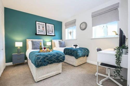 a bedroom with two beds and a table and a chair at Berrywood House - Close to Northampton Town Centre - Free Parking, Fast Wifi, SmartTV with Netflix by Yoko Property in Northampton