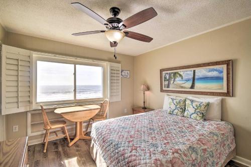 a bedroom with a bed and a table and a ceiling fan at Sun-Dappled Condo with Balcony and Secluded Beach! in Myrtle Beach