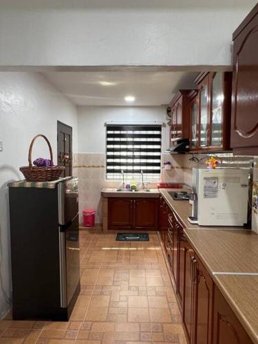 a kitchen with a black refrigerator and a sink at One's Homestay in Seri Manjung