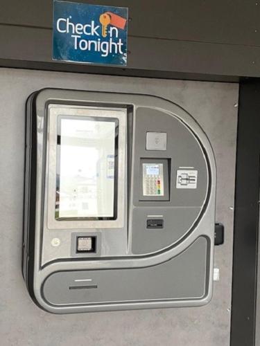 a atm machine in a building with a sign at Gästehaus Sonne in Bütschwil