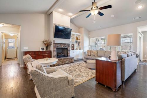 a living room with a couch and a fireplace at Near Hiking and Biking Convenient Home in Rogers! in Rogers