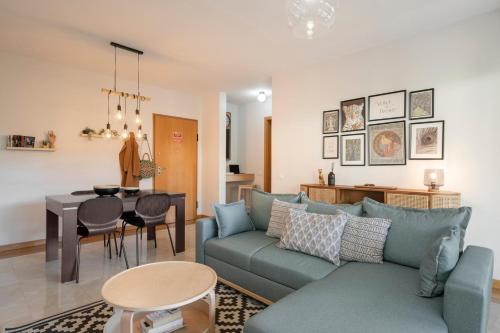 a living room with a couch and a table at Comboio I by An Island Apart in Funchal