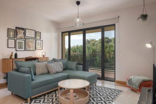 a living room with a couch and a table at Comboio I by An Island Apart in Funchal