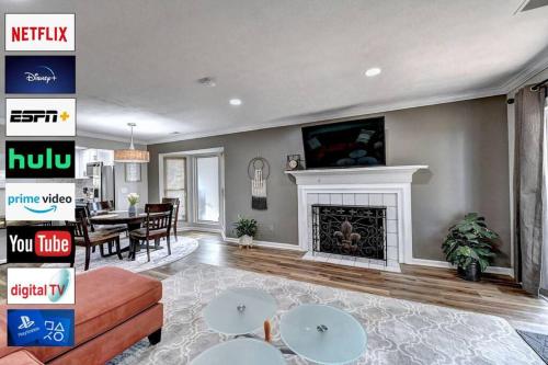 a living room with a fireplace and a tv at Quiet/Private/Easy. Walk to restaurants/shops in Alpharetta
