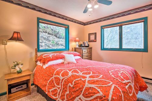 a bedroom with a bed and two windows at Burnsville Hideaway with Deck and Panoramic Mtn Views in Burnsville