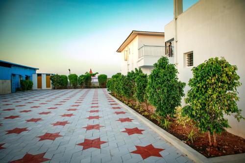 a tile driveway with stars on it next to a building at Thai Beach Resort in Thiruchendur