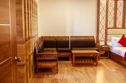 a living room with a couch and a bed at Thai Beach Resort in Tiruchchendūr