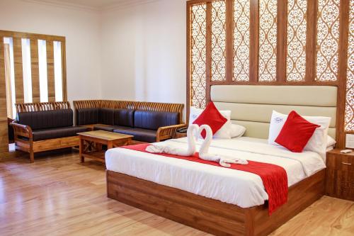 a bedroom with a bed with a swan on it at Thai Beach Resort in Thiruchendur
