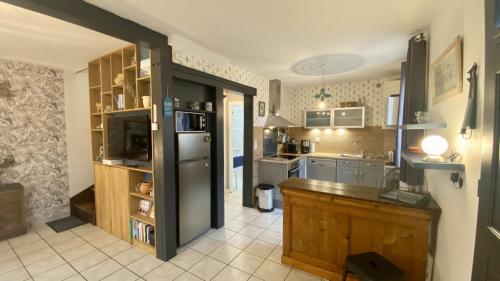 une cuisine avec un réfrigérateur en acier inoxydable et un comptoir dans l'établissement Les Volets Bleus, à Saint-Valery-sur-Somme