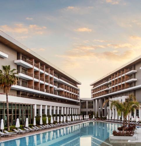 a rendering of the exterior of a resort with a swimming pool at Acanthus Cennet Barut Collection - Ultra All Inclusive in Side