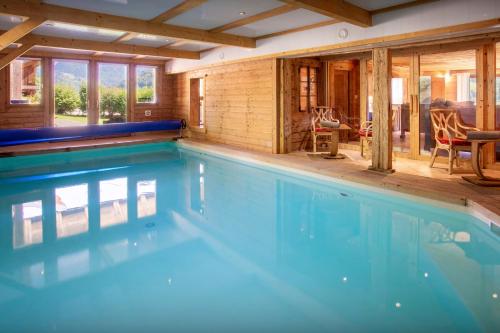 a large swimming pool in a house at Chalet Cashmere Spirit - OVO Network in Manigod