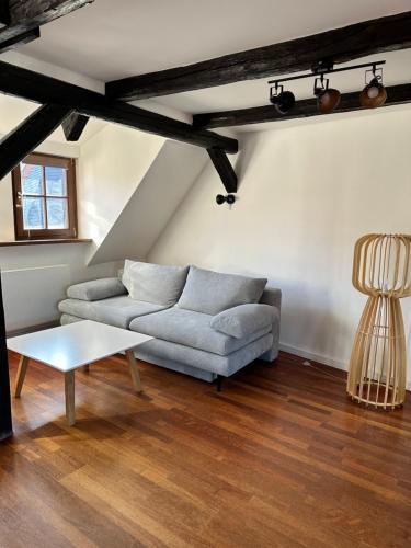 a living room with a couch and a table at Gästehaus Glücksmoment in Erfurt