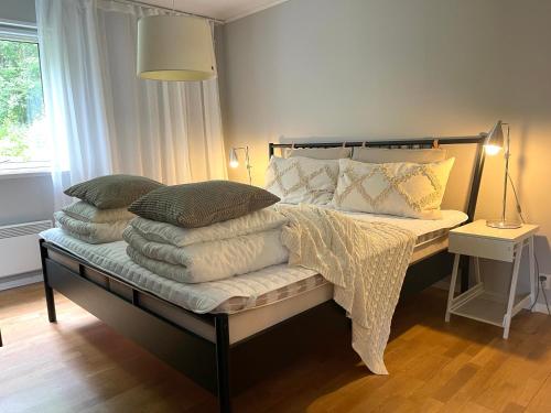 a bedroom with a bed with pillows and a lamp at Åre Travel - Villa Solbringen eller Lilla Sol in Åre