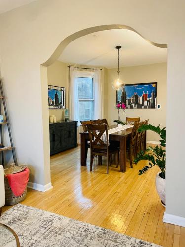 a dining room with a table and chairs at Sunny, Spacious, 3BR 1BA Davlin INN Chicago in Chicago