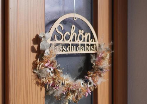 a wreath on a door with a sign on it at Mühlbauerhof in Großklein