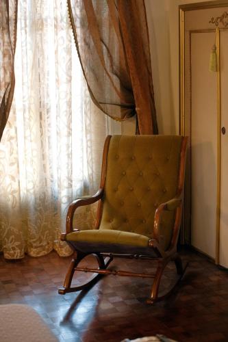 a chair sitting in front of a window at Villa Albaluce in Caluso