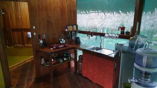 a small kitchen with a counter and a sink at Amaca Eco Station in Iquitos