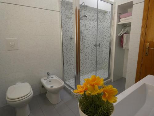a bathroom with a toilet a sink and a shower at Casa LorEn in Pesaro