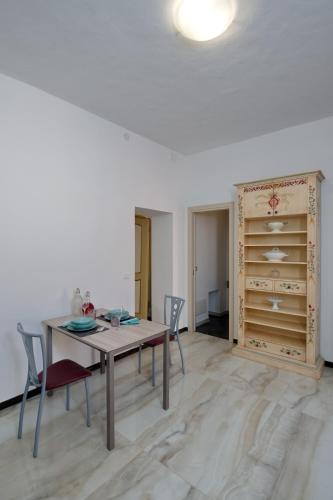 a dining room with a table and chairs and a closet at Villa Albaluce in Caluso