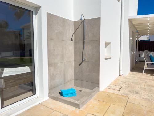 a bathroom with a shower with a blue bowl at Ayia Napa Holiday Villa 040 in Ayia Napa