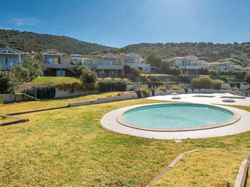 a pool in a yard with houses in the background at Villa Belvedere in Terra Mala
