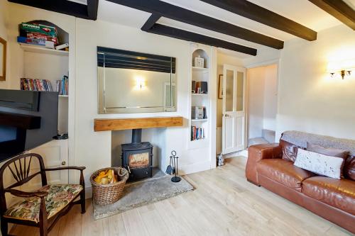 a living room with a couch and a fireplace at Host & Stay - Rose Cottage, Pickering in Pickering