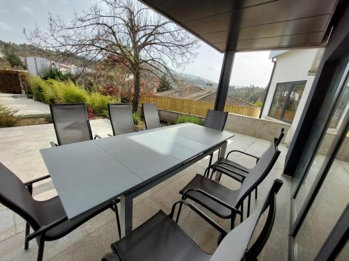 a white table and chairs on a patio at Casa dos Remendos - Alojamento Local in Termas de Sao Pedro do Sul