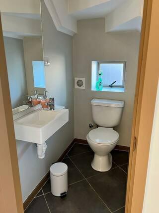 a bathroom with a white toilet and a sink at Casa Nueva Sector Oriente Talca in Talca