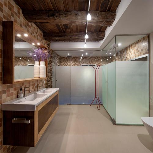 a bathroom with a sink and a glass shower at A Casacuberta in Marquiño